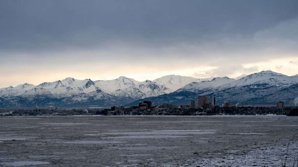 Downtown Anchorage with mountains in the background at sunset