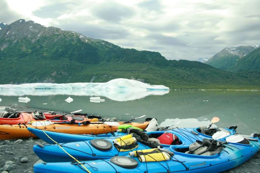 Kayaks in front of an iceberg in Chugach National Forest